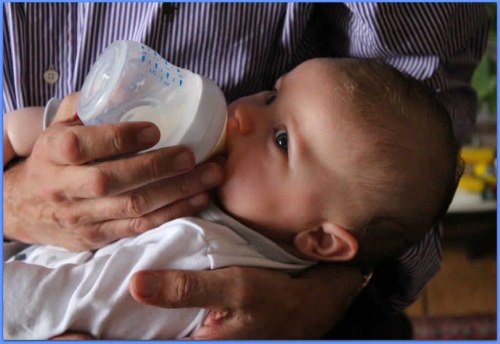 baby feeding on bottle