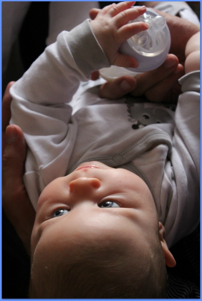 baby with bottle expressing and feeding