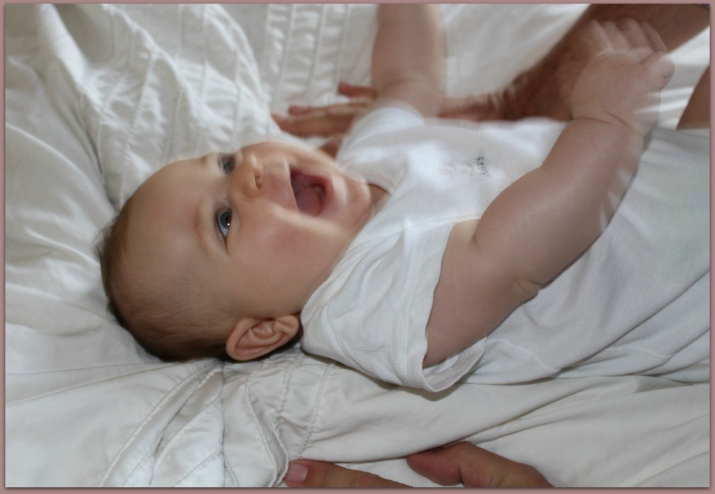 laughing baby on bed