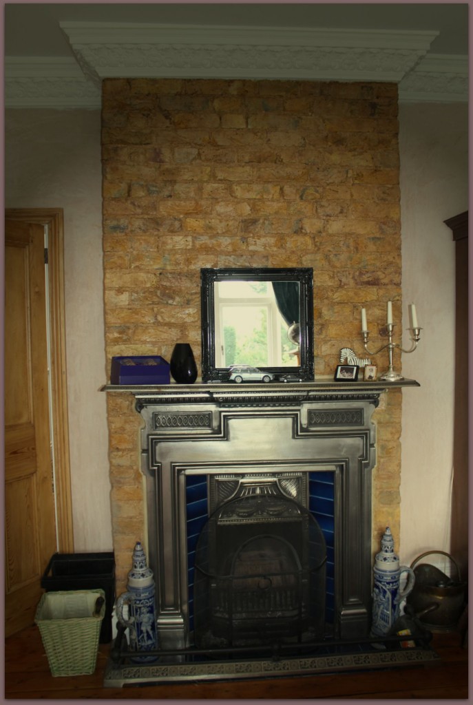 Victorian fireplace with bare brickwork 