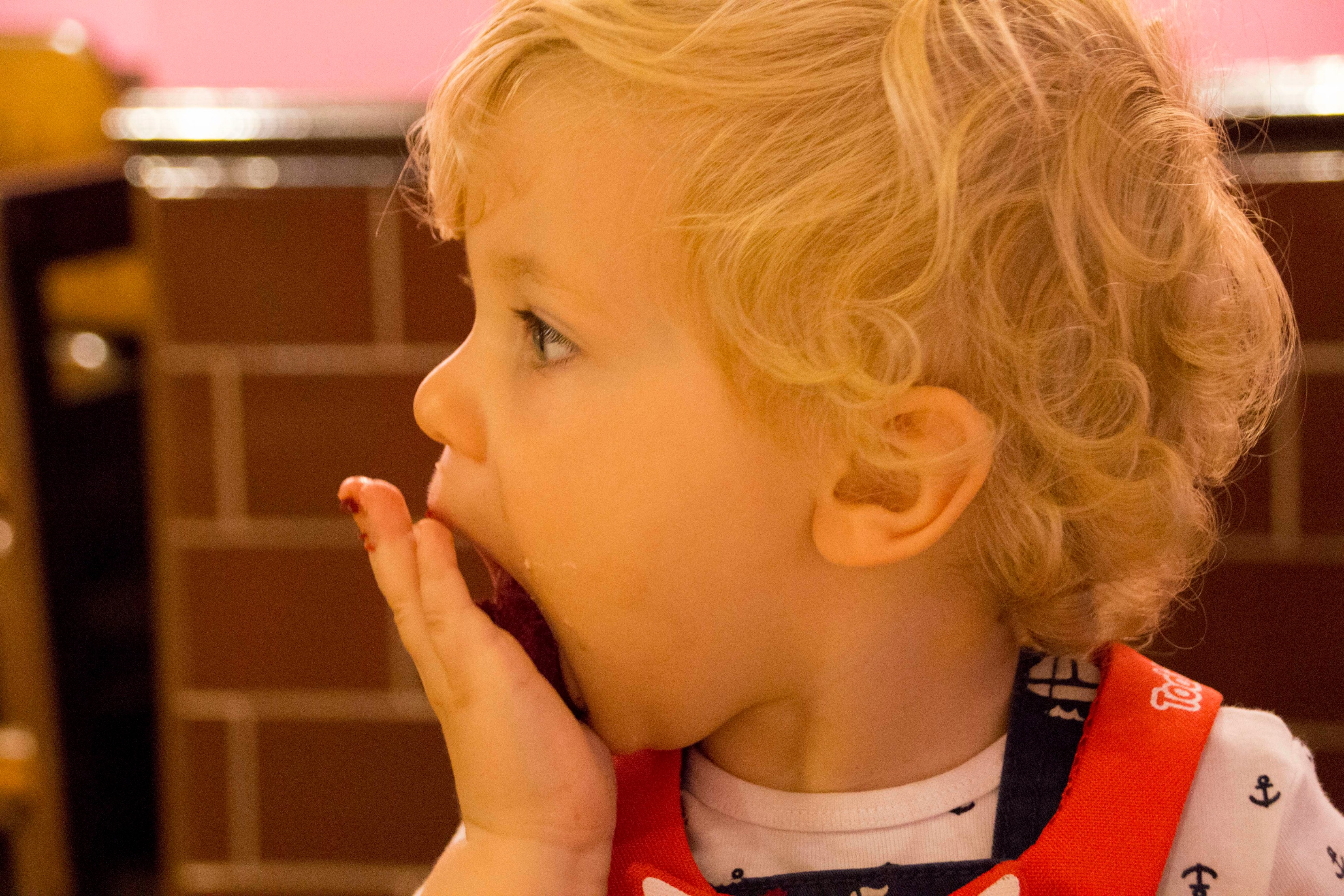 Boy stuffing cake in his mounth