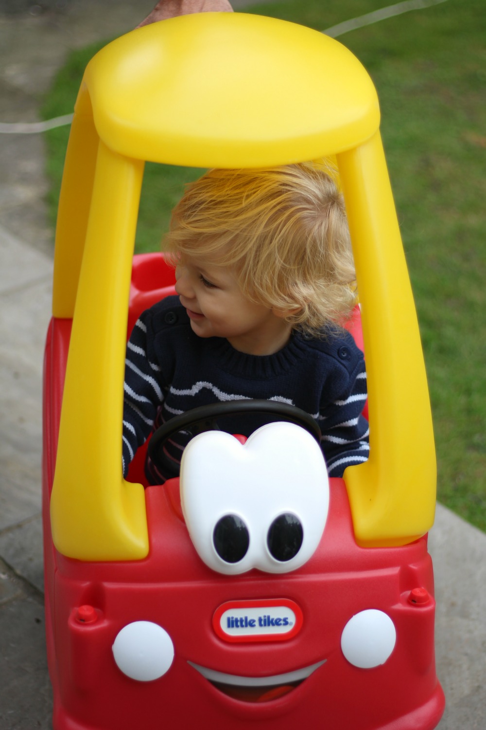 Happy boy in the always happy Cozy Coupe from Little Tikes