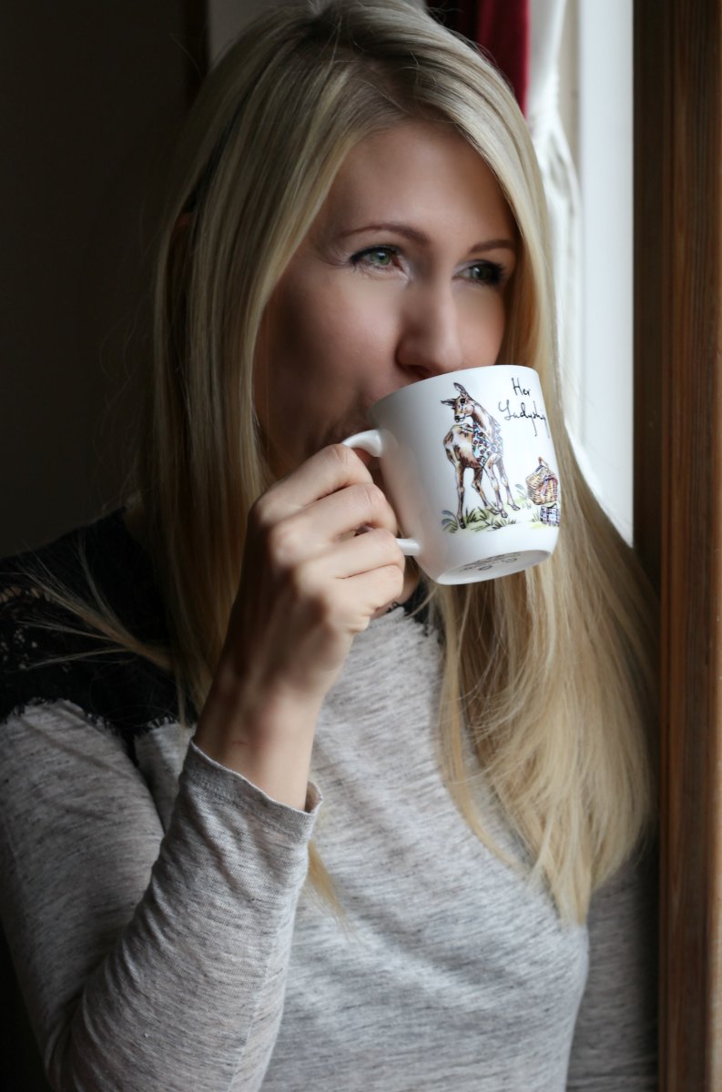 Woman drinking coffee from mug with stag print from QWERKITY