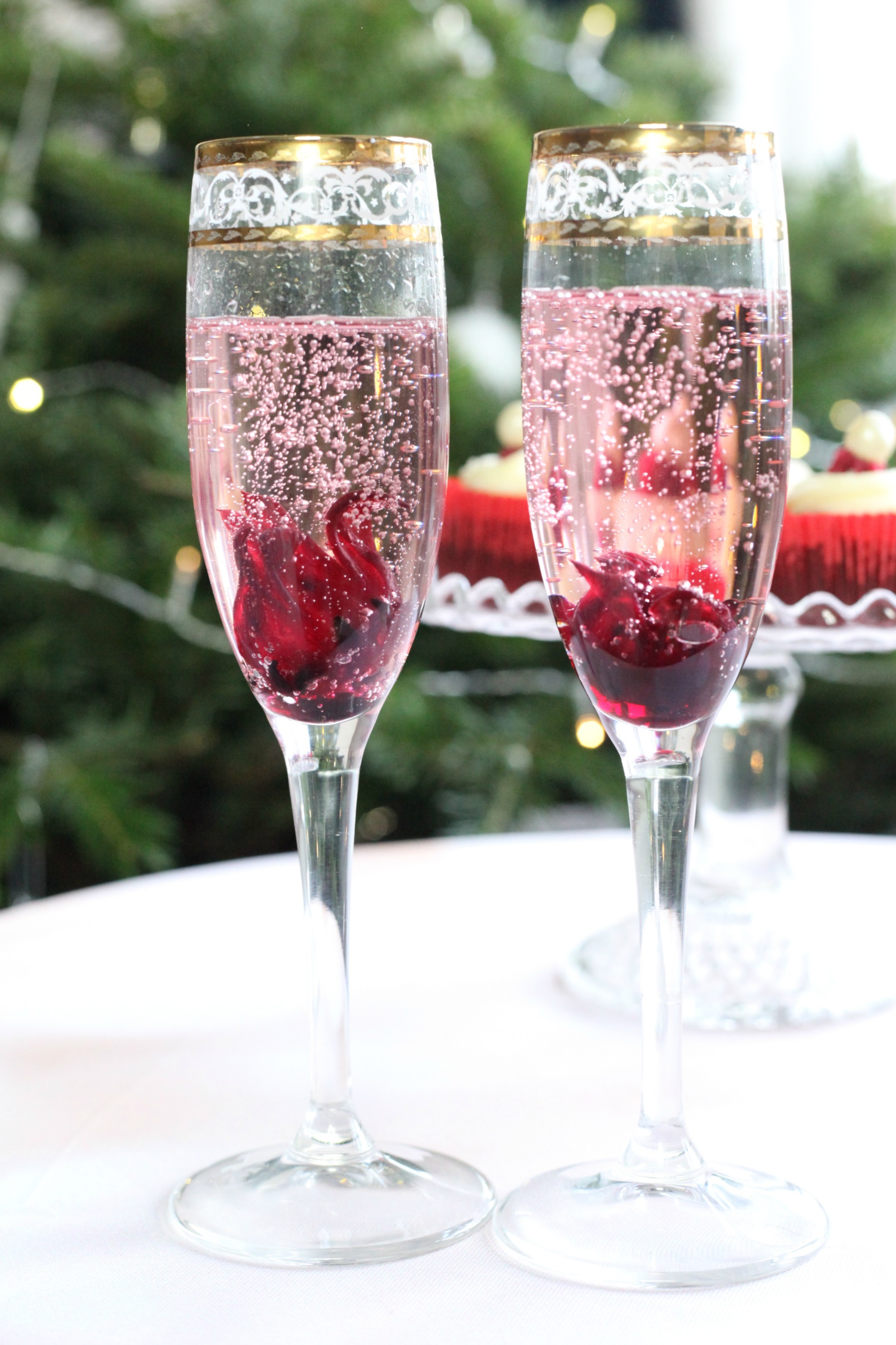 Adding wild hibiscus flowers make for festive Christmas cocktails.