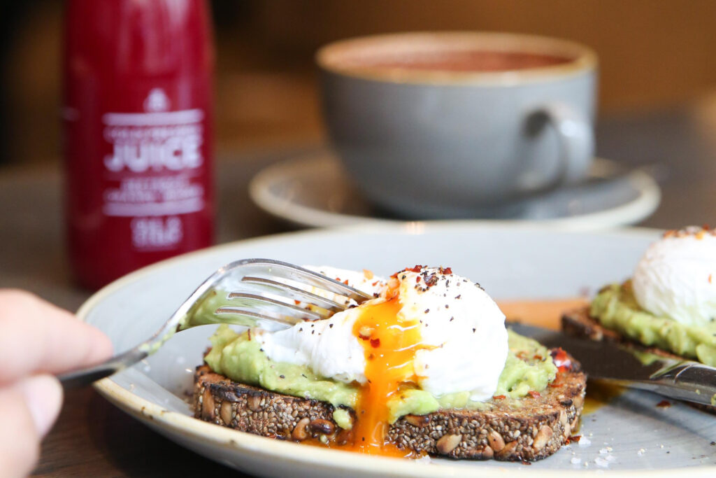 Poached egg on smashed avocado and chia rye as the best Scandinavian brunch in London